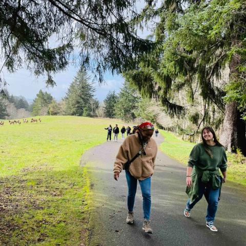 mentors walking outside on a path with students behind them