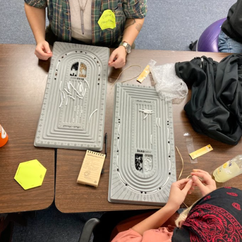 students creating beaded work
